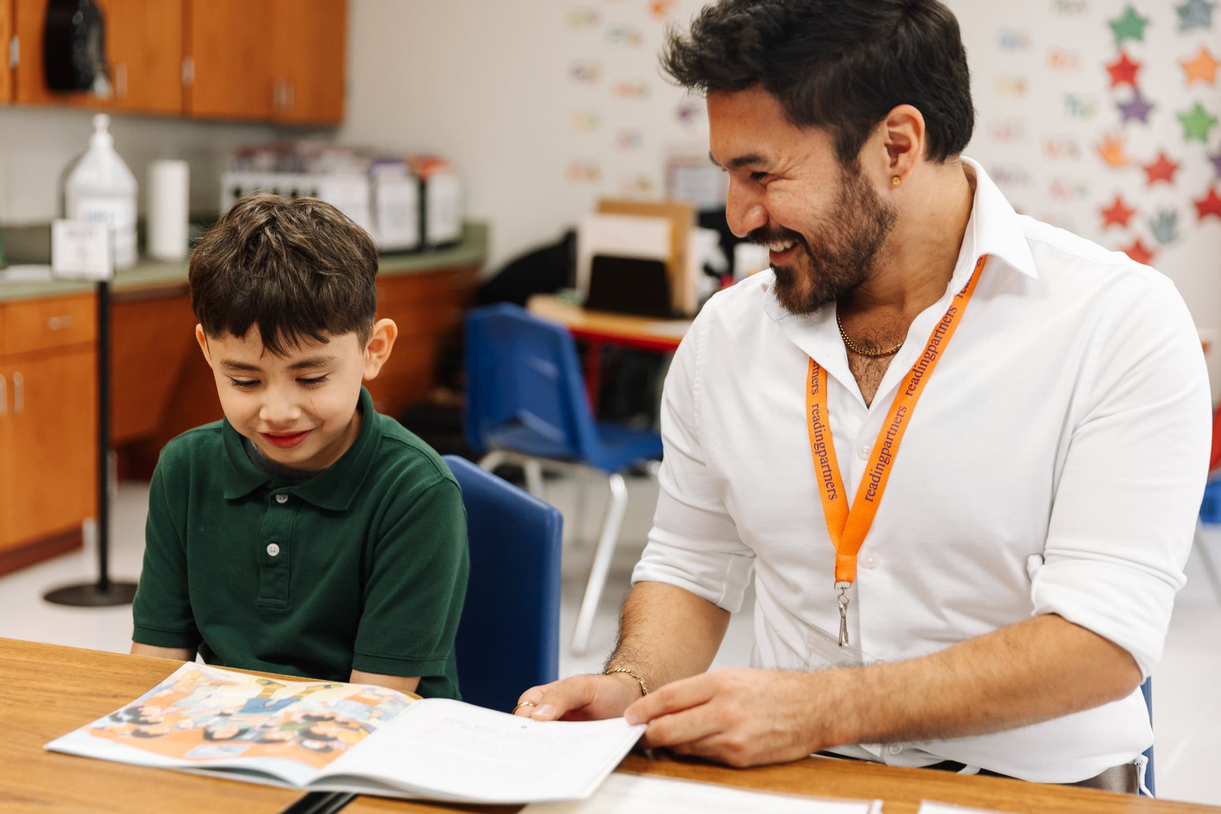 Student and tutor reading a book